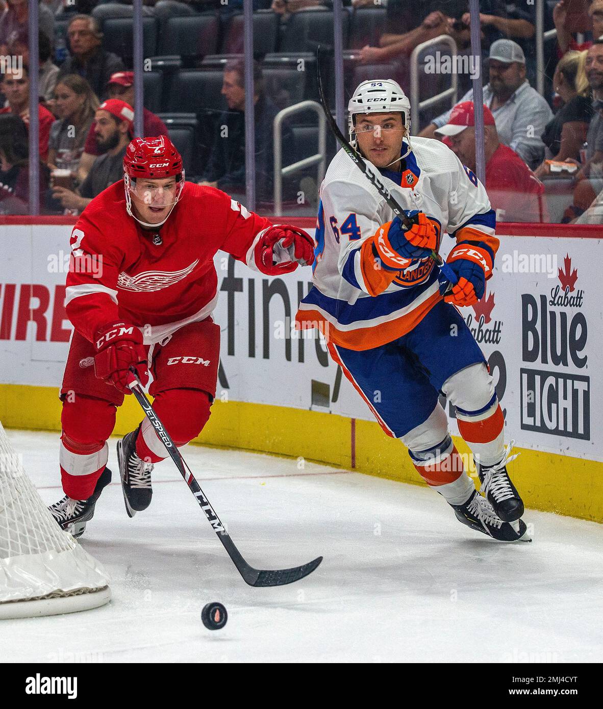 Detroit Red Wings defenseman Joe Hicketts (2) competes for the puck with  New York Islanders forward Nick Schilkey (64) in the first period of a  preseason NHL hockey game, Friday, Sept. 20