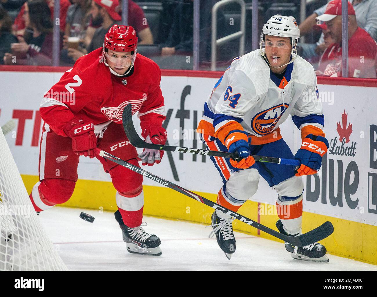 Detroit Red Wings defenseman Joe Hicketts (2) competes for the puck with  New York Islanders forward Nick Schilkey (64) in the first period of a  preseason NHL hockey game, Friday, Sept. 20