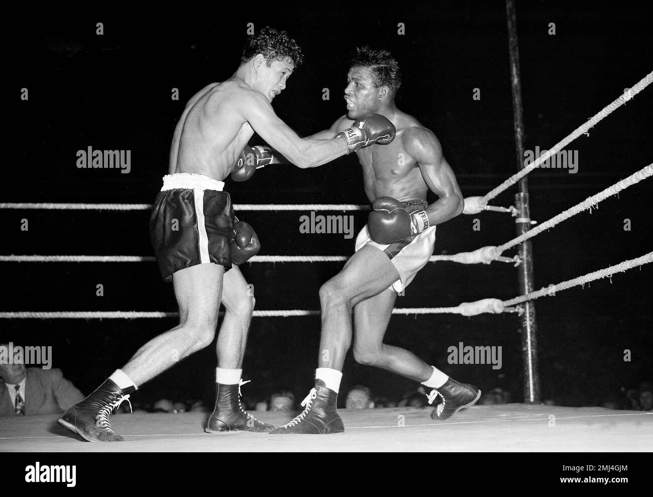 Sugar Ray Robinson, right, world welterweight champion, savagely