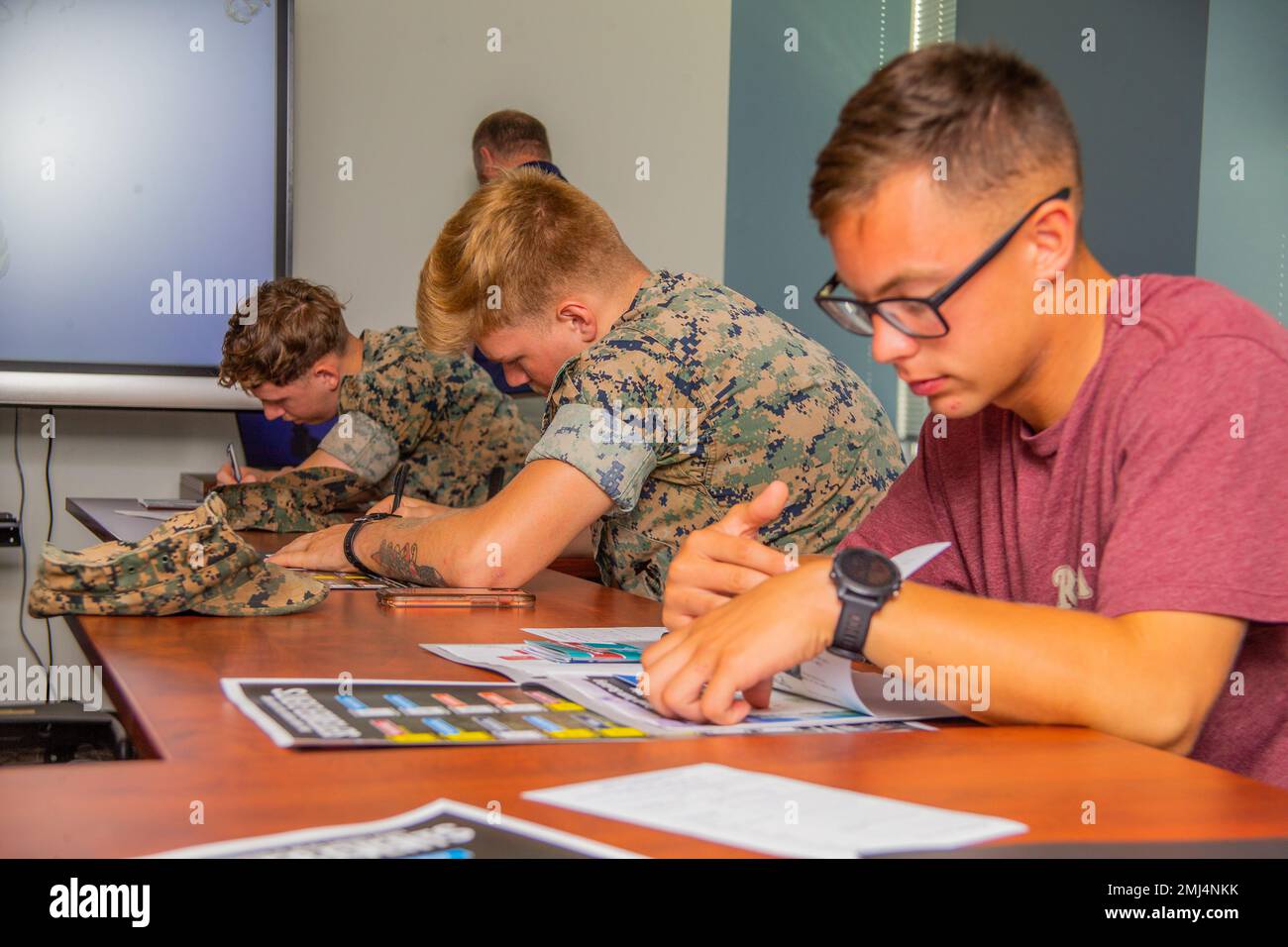 U.S. Marines take notes during a Single Marine Representative Seminar at Marine and Family Programs, Marine Corps Air Station Cherry Point, North Carolina, Aug. 25, 2022. The seminar provides attendees knowledge of the Single Marine Program (SMP) and what their job as unit representatives will entail. Stock Photo