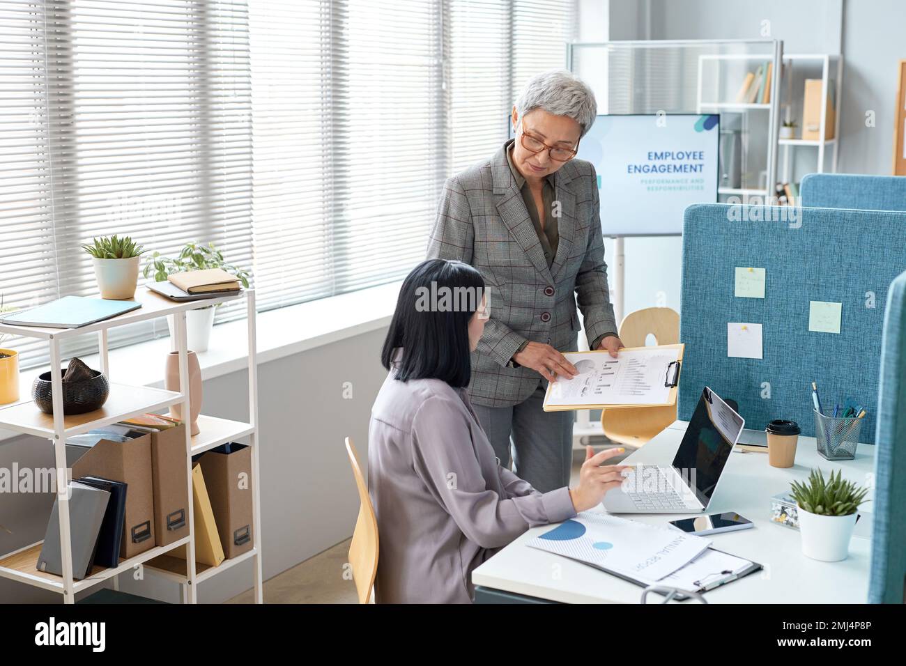 Portrait of senior business manager instructing employees in office setting, copy space Stock Photo