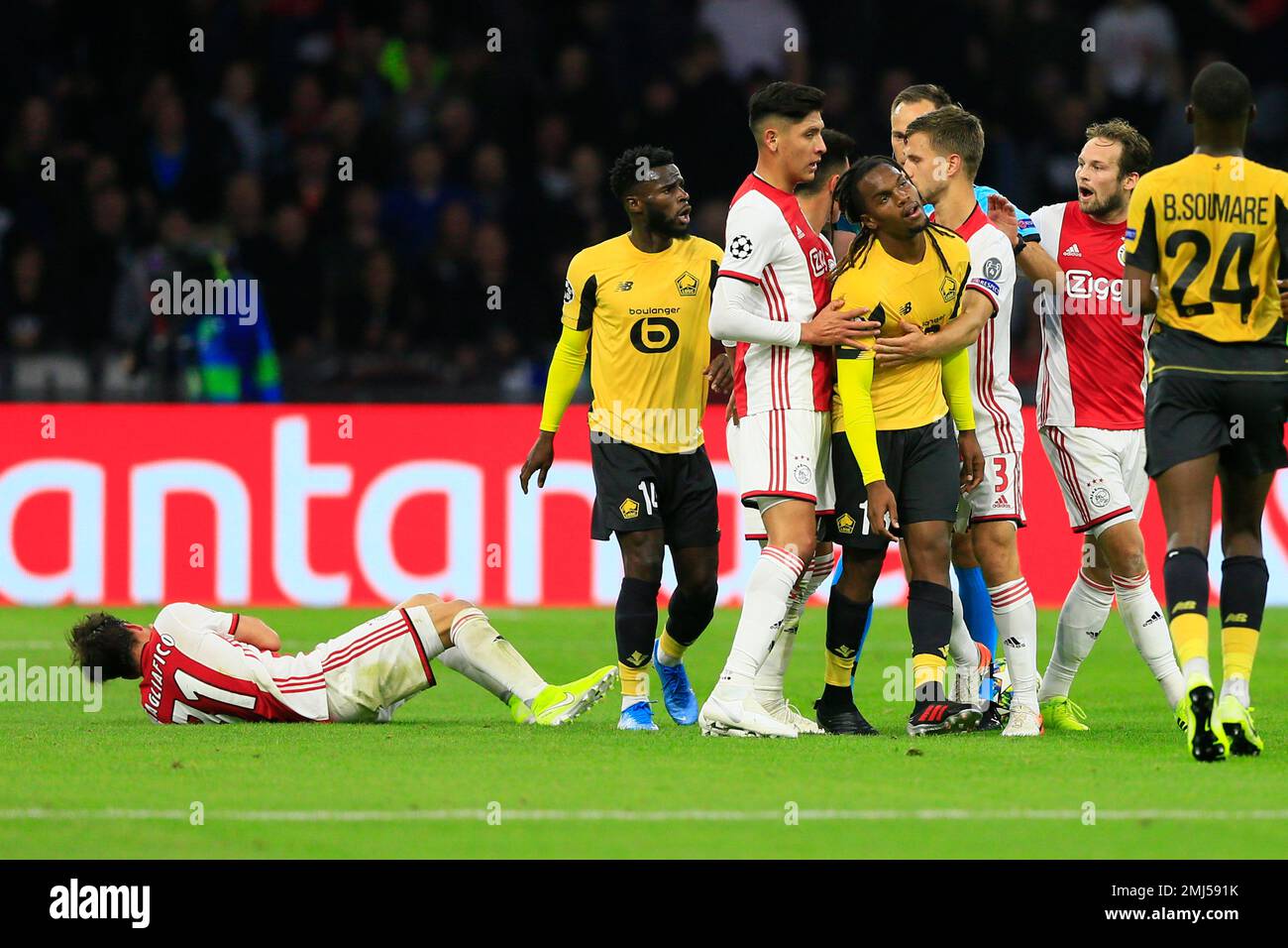 Lille's Renato Sanches, center, is led away after pushing Ajax's Dusan  Tadic, left, to the ground during the group H Champions League soccer match  between Ajax and LOSC Lille at Johan Cruyff