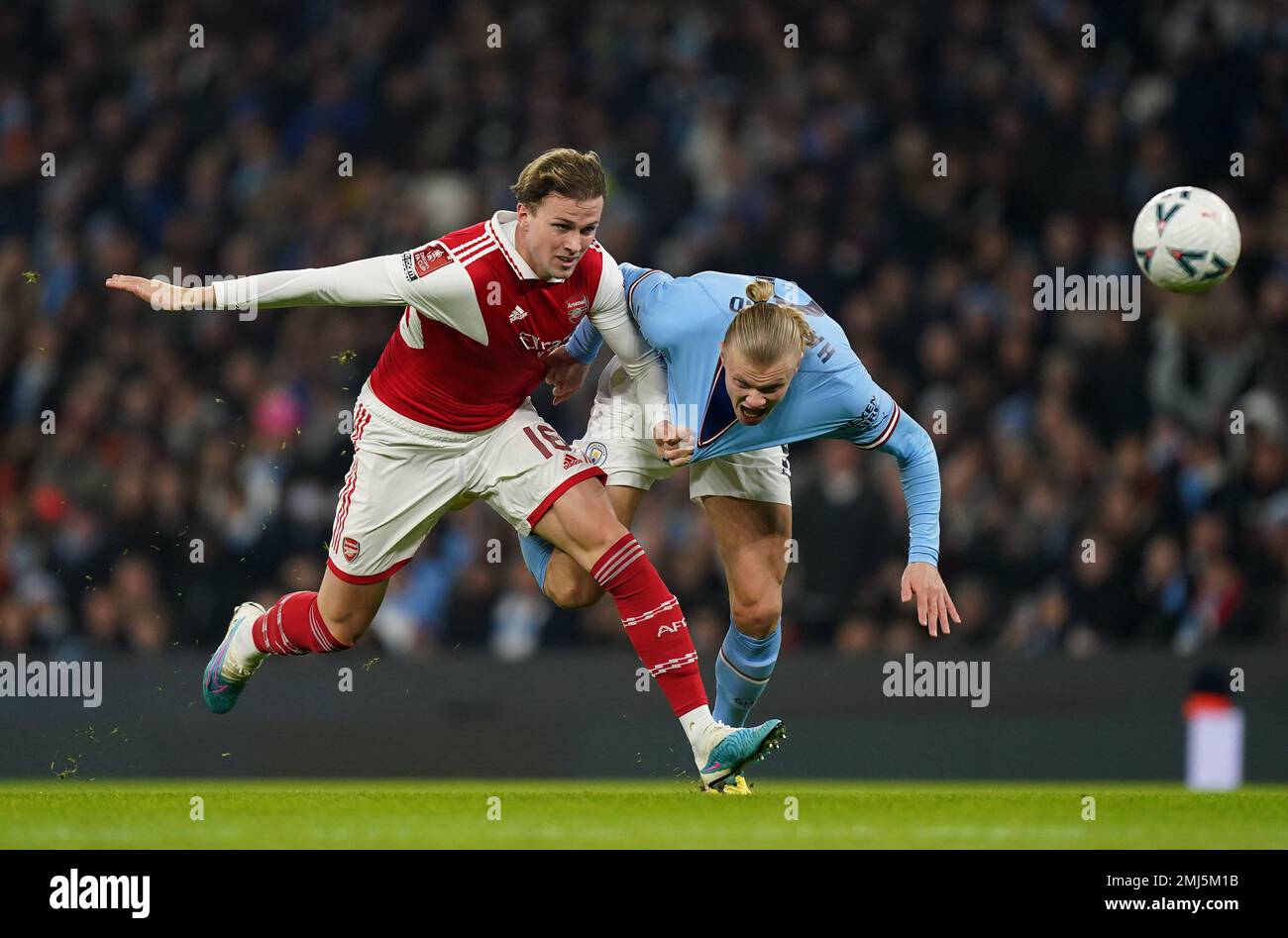 Arsenal's Rob Holding (left) and Manchester City's Erling Haaland battle for the ball during the Emirates FA Cup fourth round match at Etihad Stadium, Manchester. Picture date: Friday January 27, 2023. Stock Photo