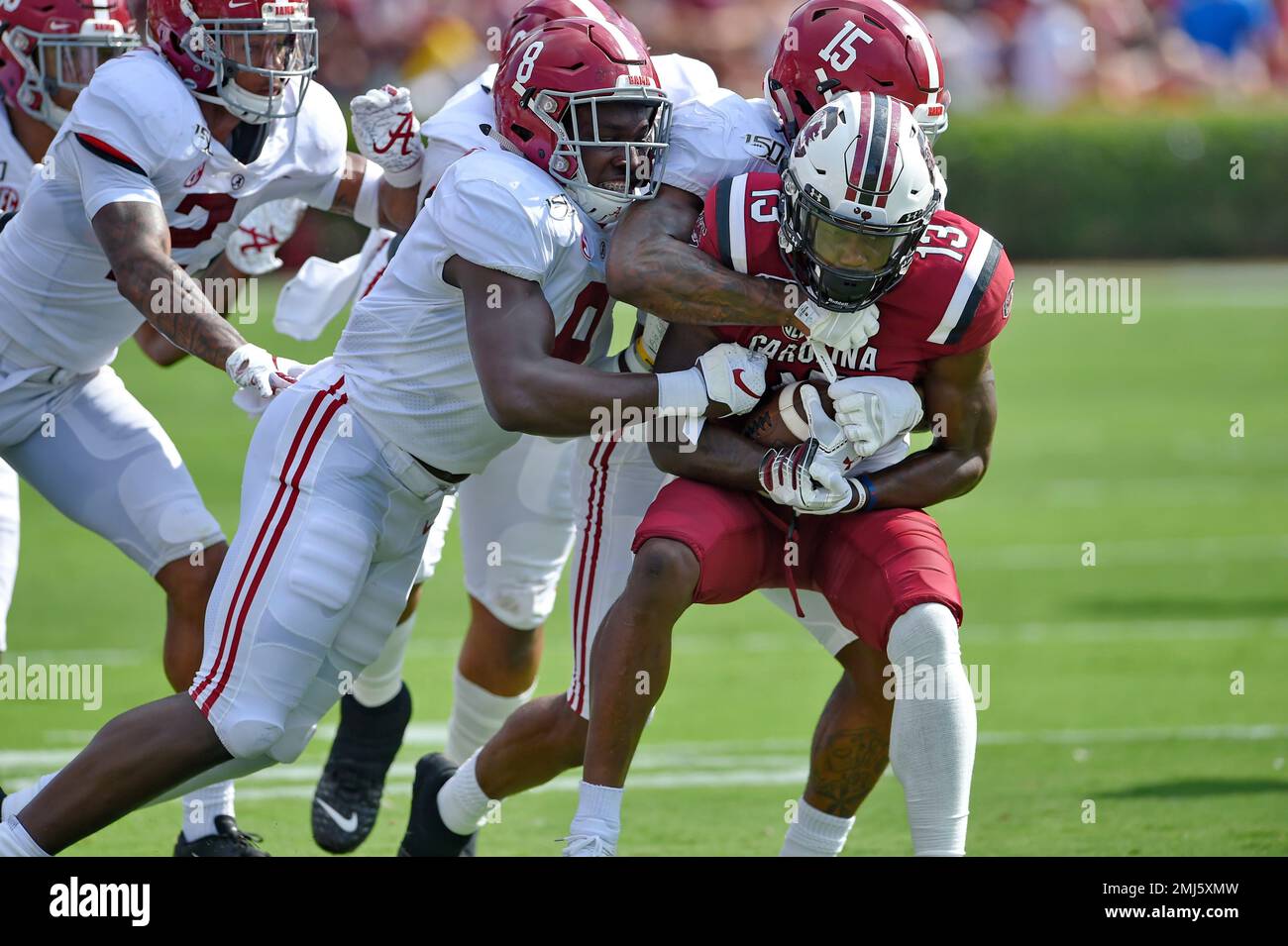 Alabama's Xavier McKinney (15) and Christian Harris tackle South