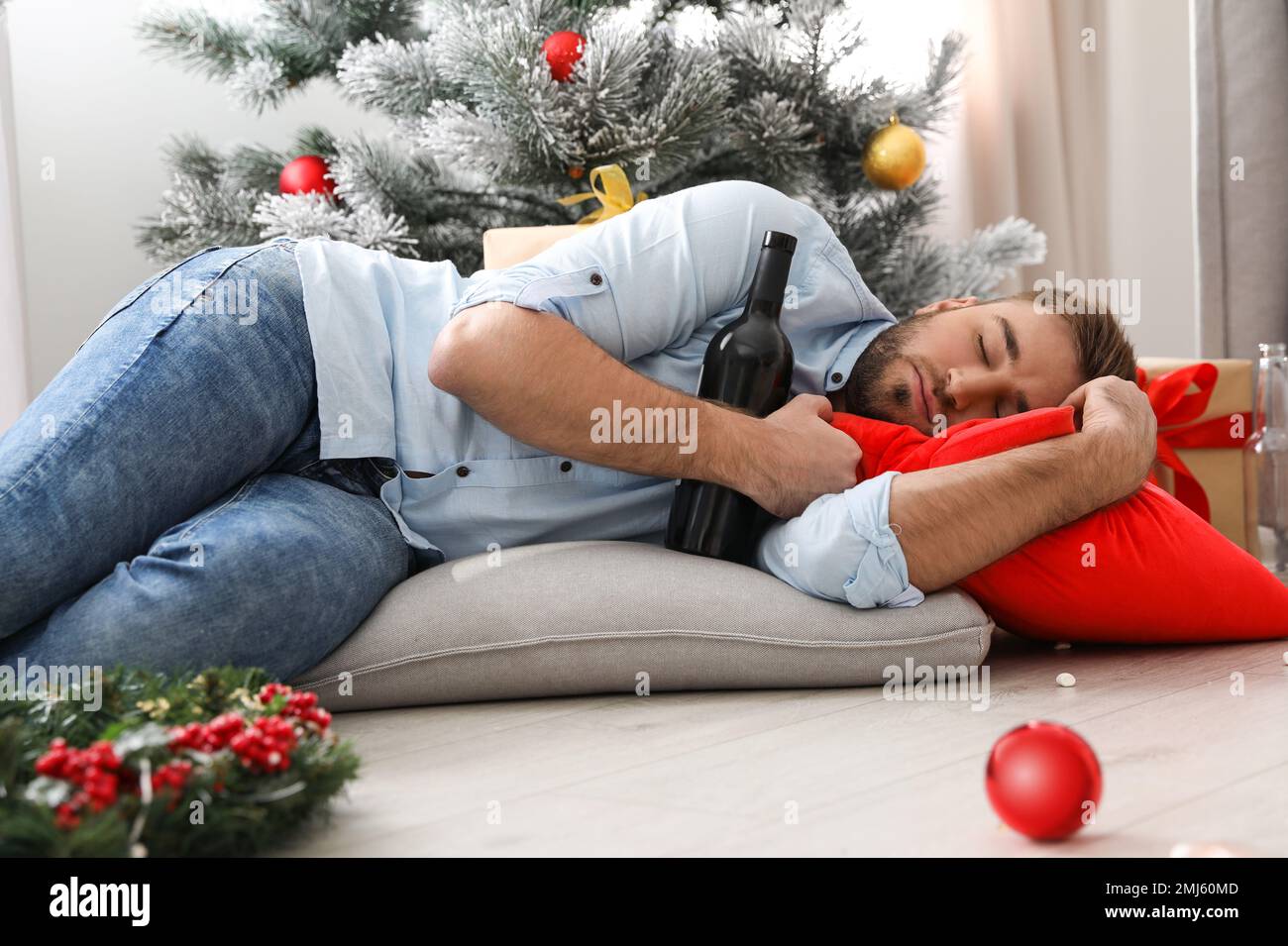 Drunk man sleeping on floor in messy room after New Year party Stock Photo Alamy