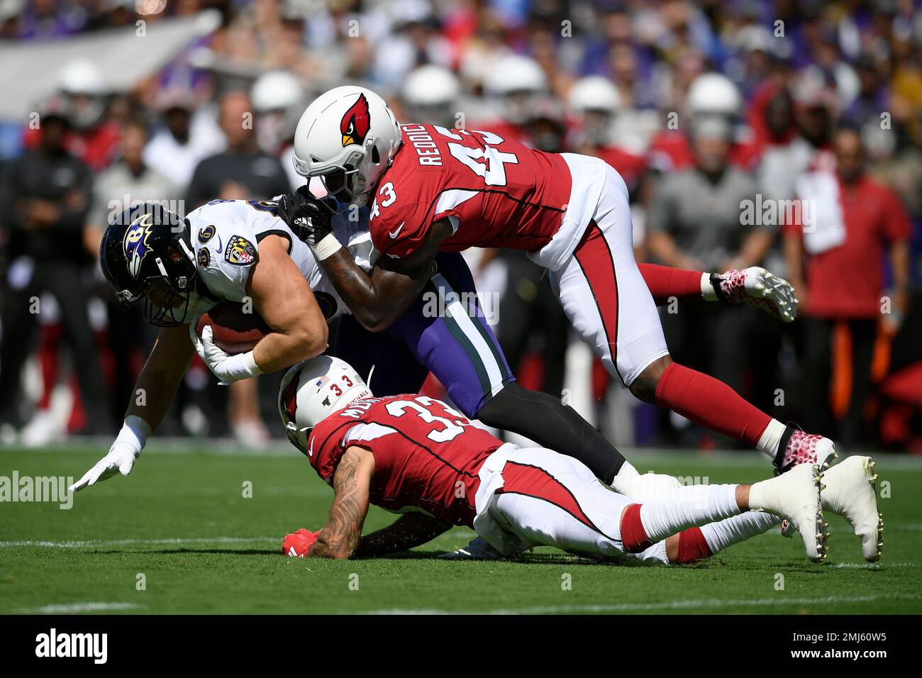 Baltimore Ravens tight end Nick Boyle, left, is tackled by Arizona