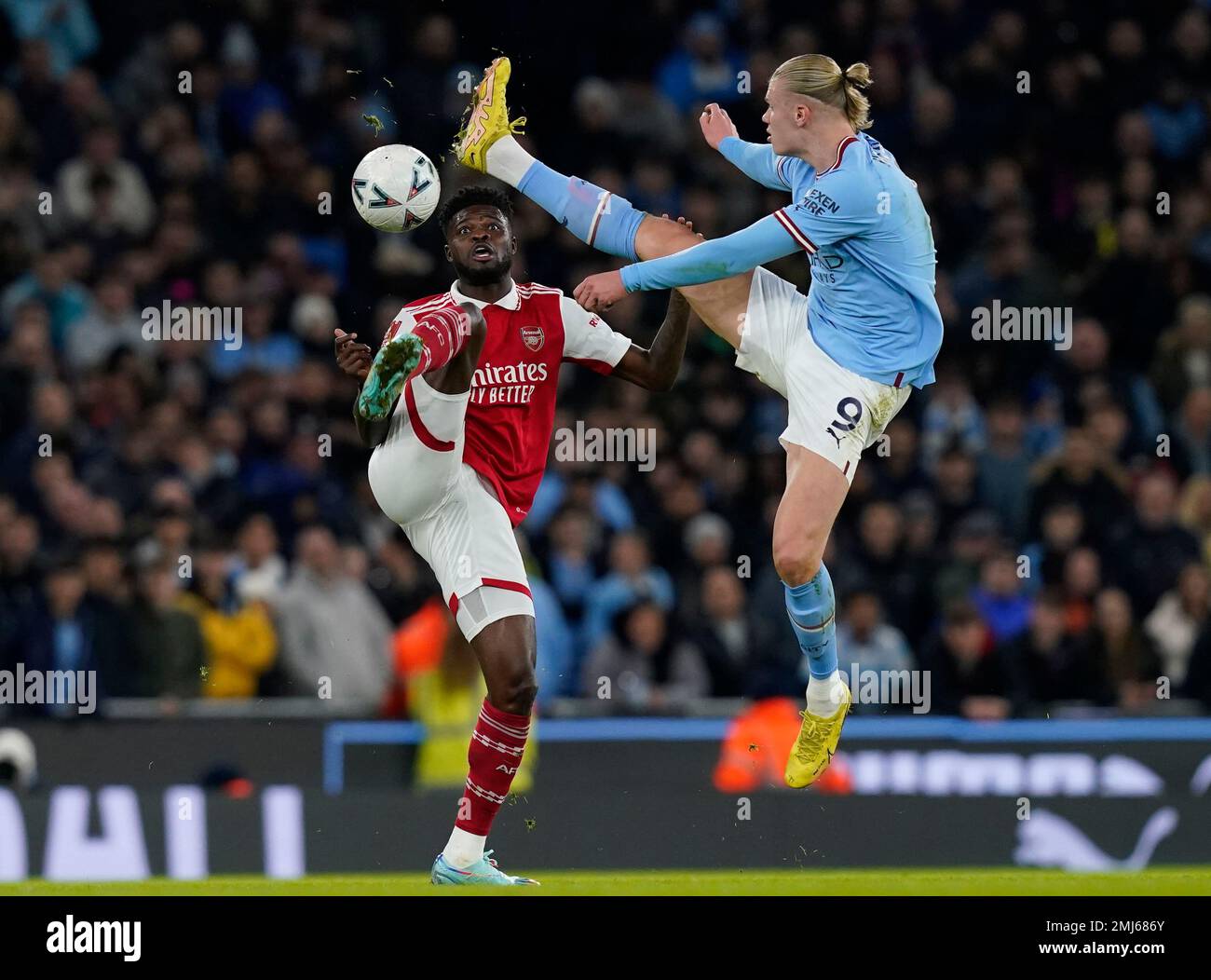 Manchester, England, 27th January 2023. Thomas Partey of Arsenal challenged by Erling Haaland of Manchester City  during the The FA Cup match at the Etihad Stadium, Manchester. Picture credit should read: Andrew Yates / Sportimage Credit: Sportimage/Alamy Live News Stock Photo