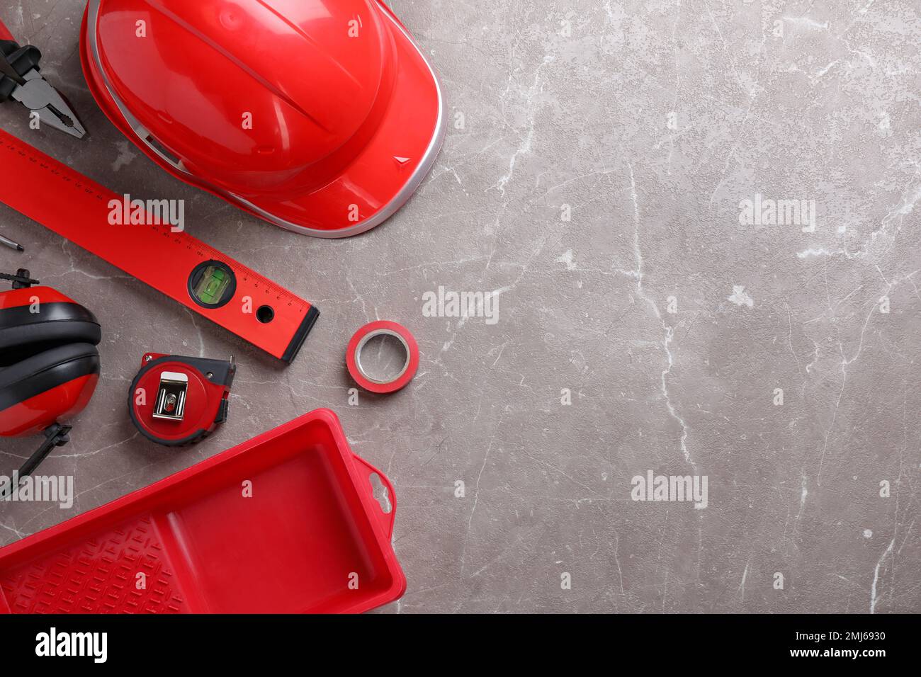Flat lay composition with different construction tools on grey marble ...