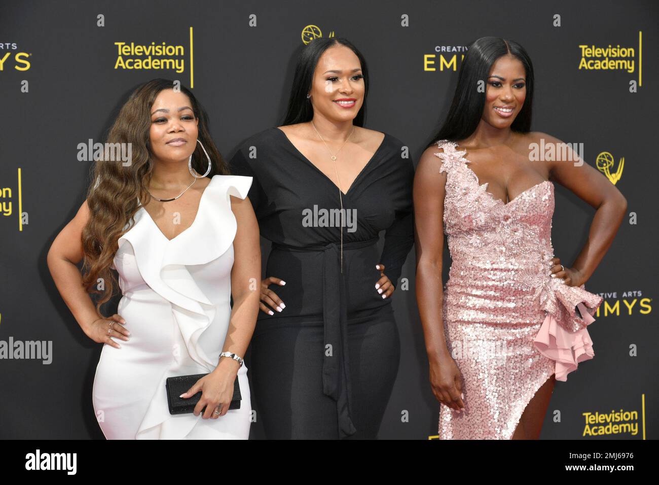 Kittie Jones, left, Lisa Van Allen, and Asante McGee arrive at night