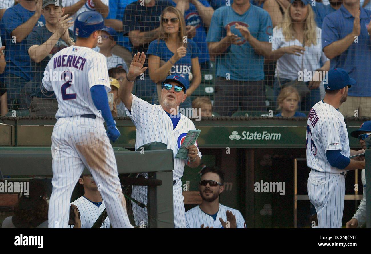 Chicago Cubs' Nico Hoerner (2) celebrates with manager Joe Maddon