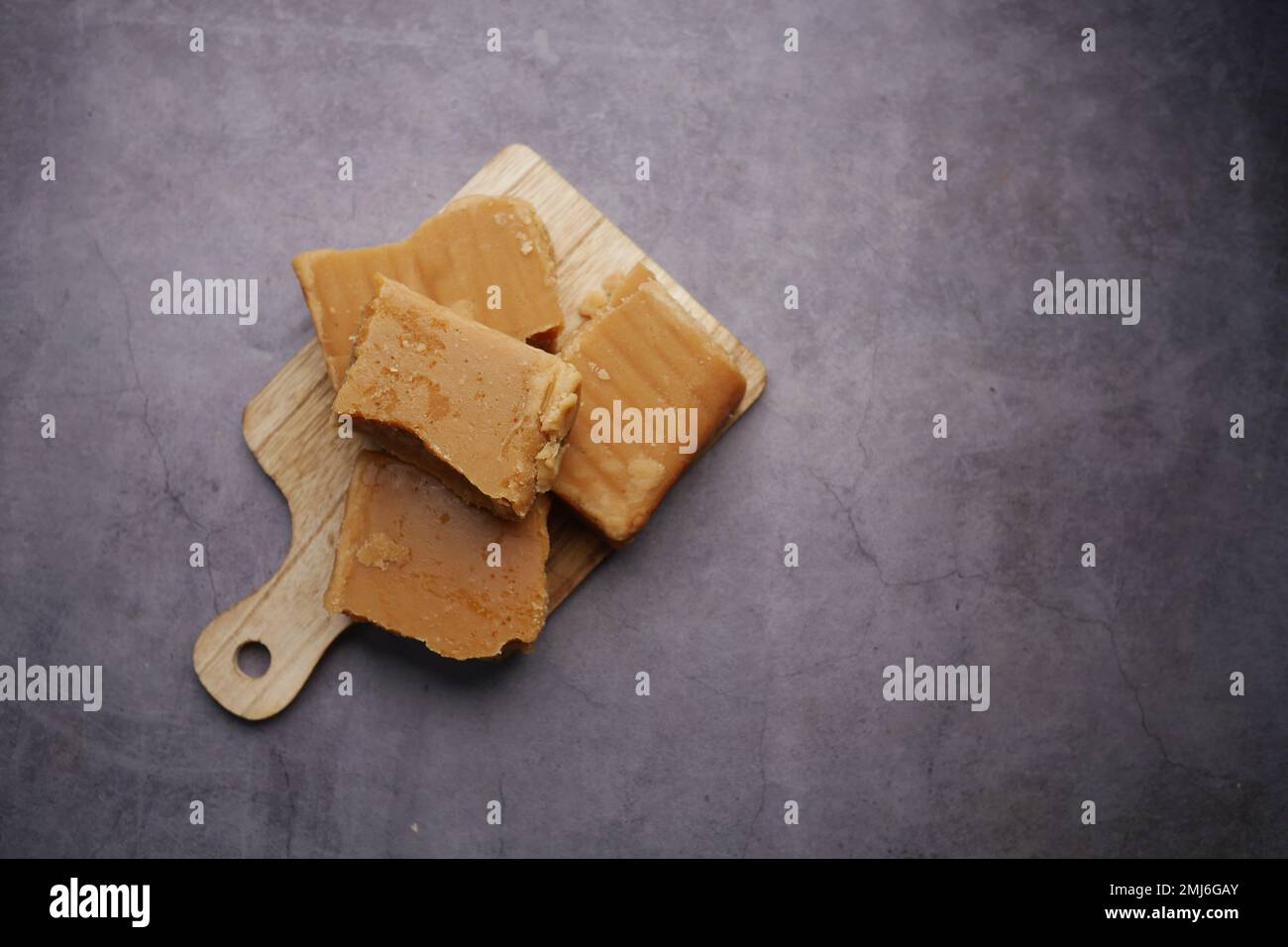 Jaggery traditional cane sugar cube on table  Stock Photo
