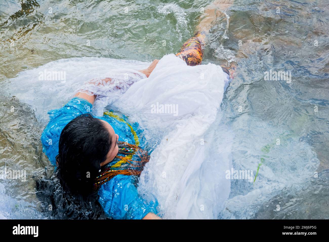 Salvador, Bahia, Brazil - February 02, 2017: Woman bathes in the sea during the party in honor of Iemanja. Salvador, Bahia. Stock Photo