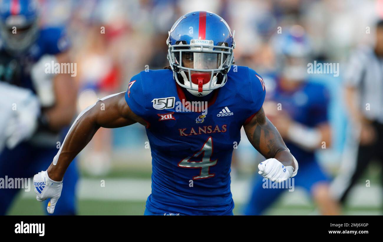 Kansas wide receiver Andrew Parchment (4) is tackled by Indiana State  linebacker Jonas Griffith during the second half of an NCAA college  football game Saturday, Aug. 31, 2019, in Lawrence, Kan. Kansas