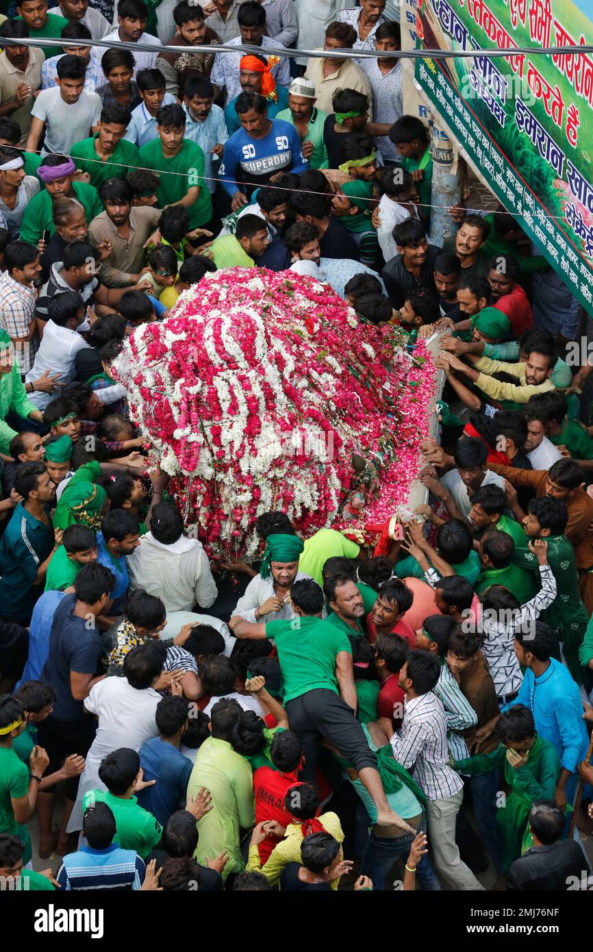 Indian Shiite Muslims take out a tableau in a religious procession to ...
