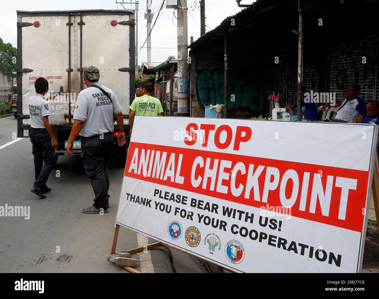 Local authorities inspect cargo vans at an animal checkpoint in ...