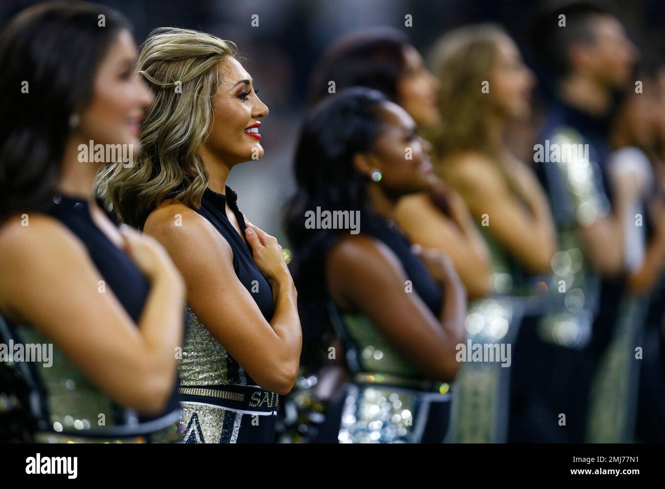 New Orleans Saints cheerleaders hold their hands to their hearts for