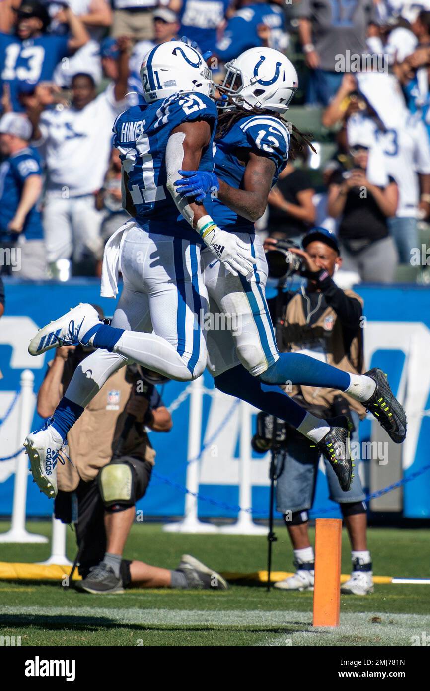 Indianapolis Colts running back Nyheim Hines (21) scores a touchdown ahead  of Tennessee Titans inside linebacker Jayon Brown (55) in the first half of  an NFL football game Thursday, Nov. 12, 2020