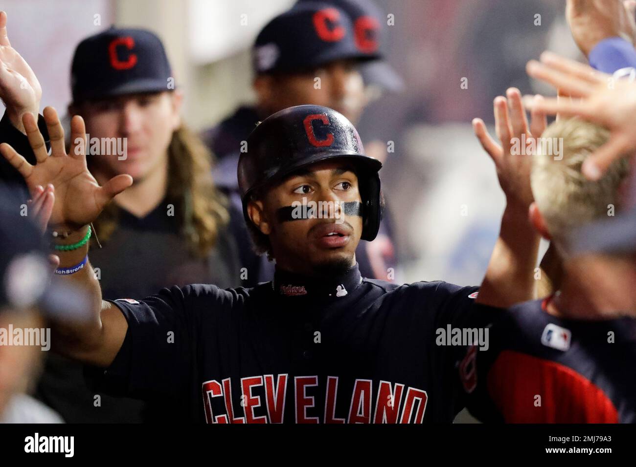 Cleveland Indians' Francisco Lindor celebrates in the dugout after