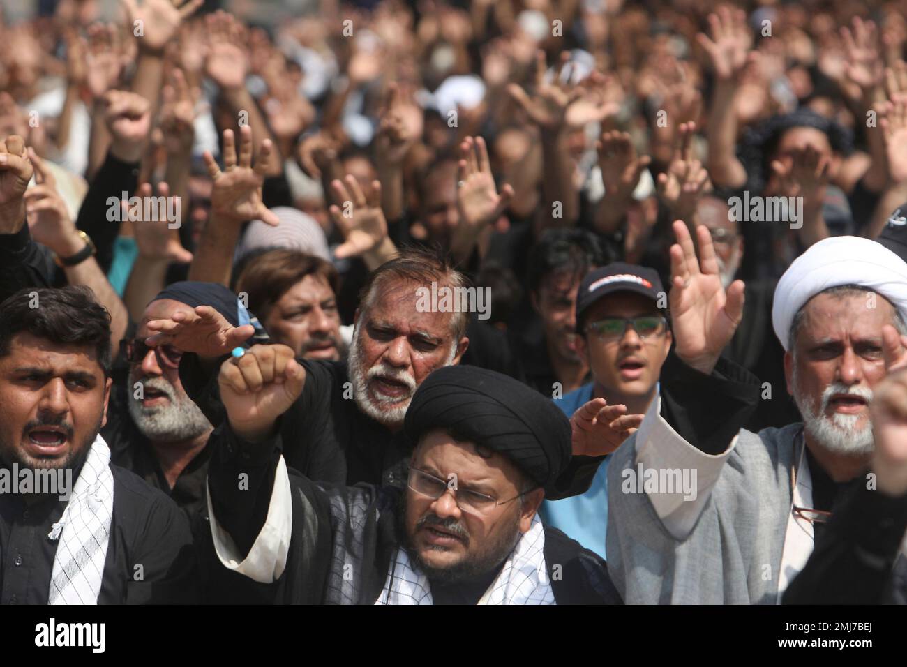 Pakistani Shiite Muslims chant slogans during a Muharram procession, in ...