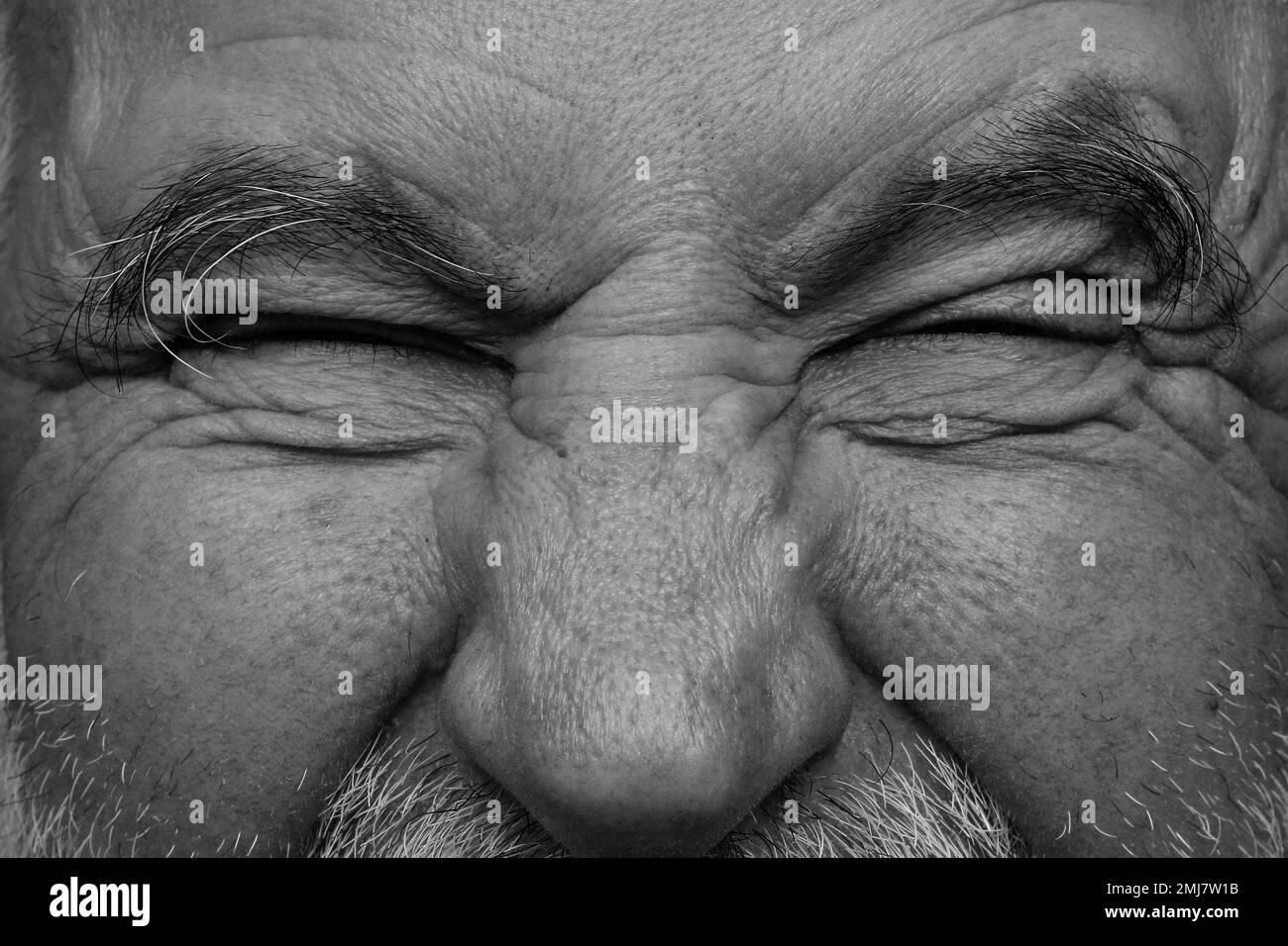 The scream in the old man's eyes. A black and white picture. Stock Photo