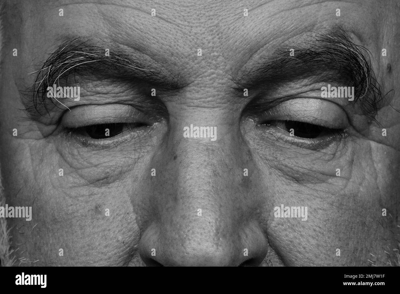 The old man's lowered gaze. Stock Photo