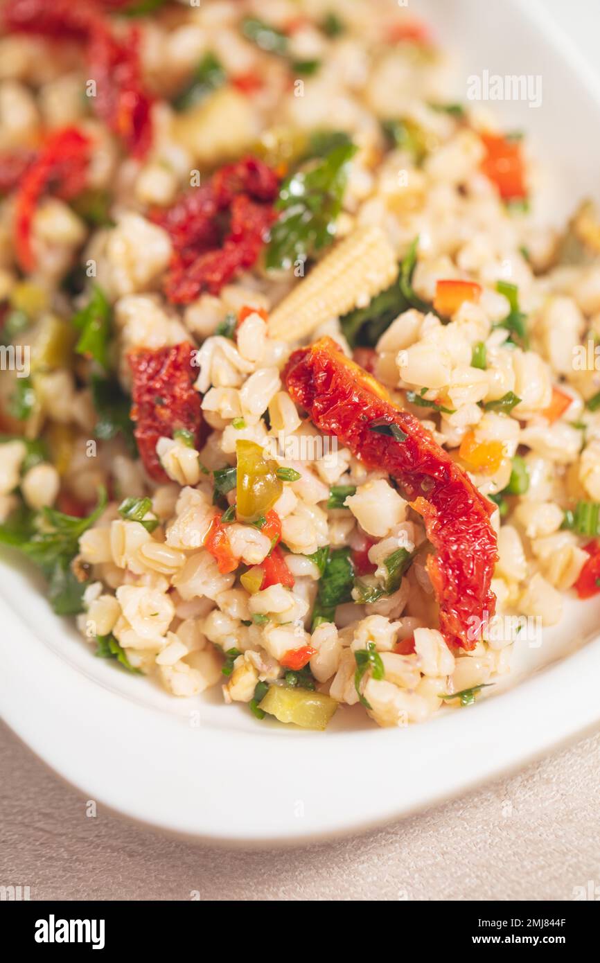 Tabbouleh salad - traditional Middle Eastern or Arabic cuisine. Levantine vegetarian salad with bulgur, quinoa, tomato, cucumber, parsley and lemon Stock Photo