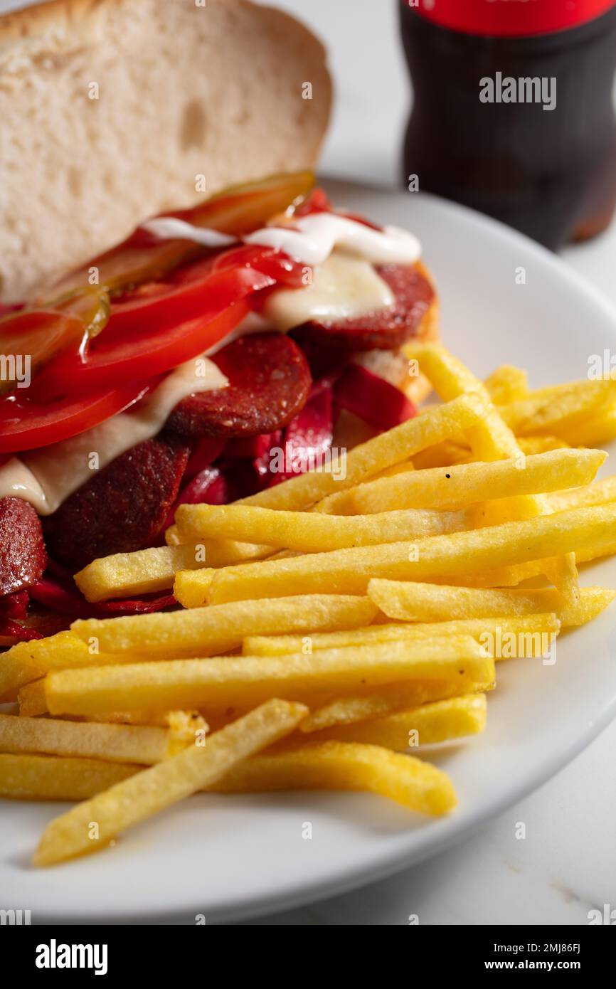 Kumru is a Turkish sandwich on a bun, typically with cheese, tomato, and sausage. The name of this street food translates as collared dove, and Stock Photo