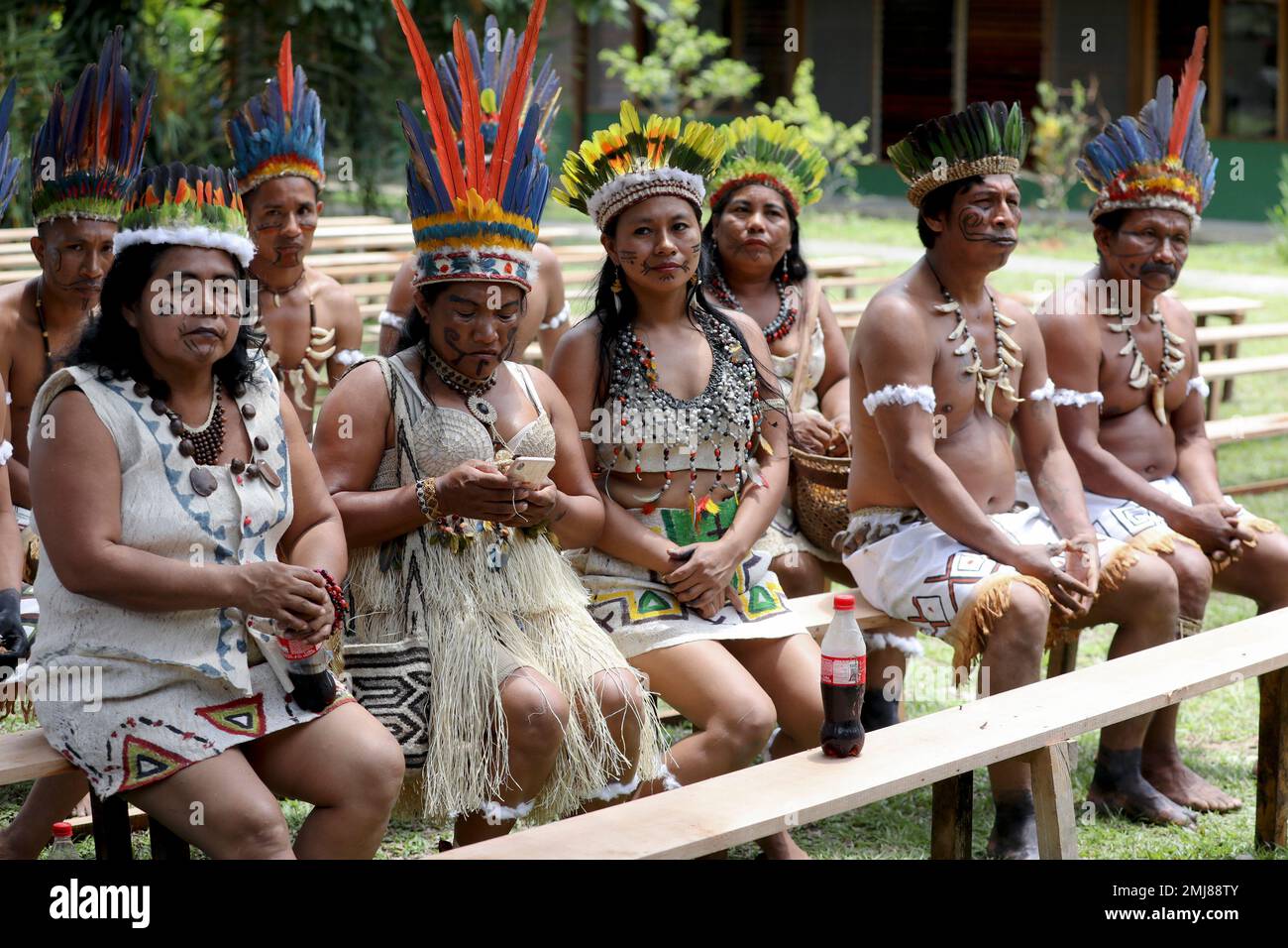 Representatives of the Huitoto and Ticuna indigenous communities sit outside the room where leaders of several South American nations that share the Amazon are meeting, in Leticia, on Colombia's Amazon river border with Brazil and Peru, Friday, Sept. 6, 2019. Presidents and representatives from several countries in South America's Amazon region met to discuss a joint strategy for preserving the world's largest rain forest, which has been under threat from a record number of wildfires.(AP Photo/Fernando Vergara) Stock Photo