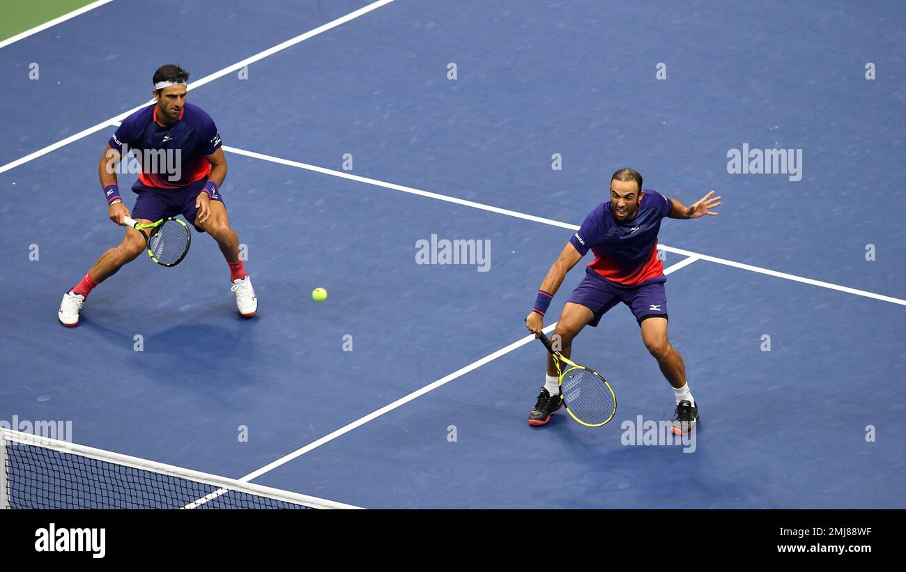Robert Farah, and Juan Sebastian Cabal, both of Colombia, return a shot to Marcel Granollers, of Spain, and Horacio Zeballos during the final match of the U.S