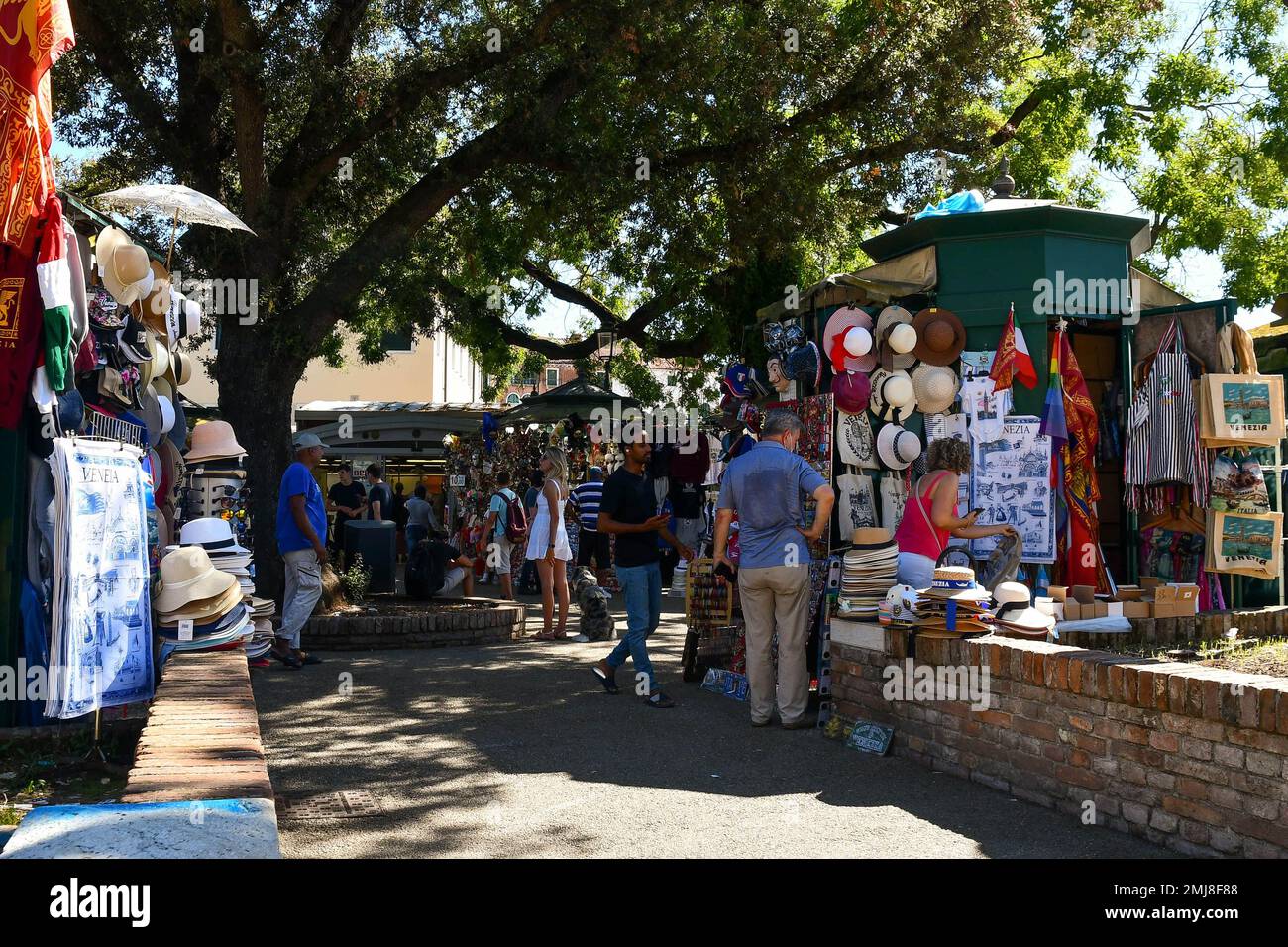 Tourists shopping souvenirs at street stalls in Piazzale Roma in summer, Venice, Veneto, Italy Stock Photo