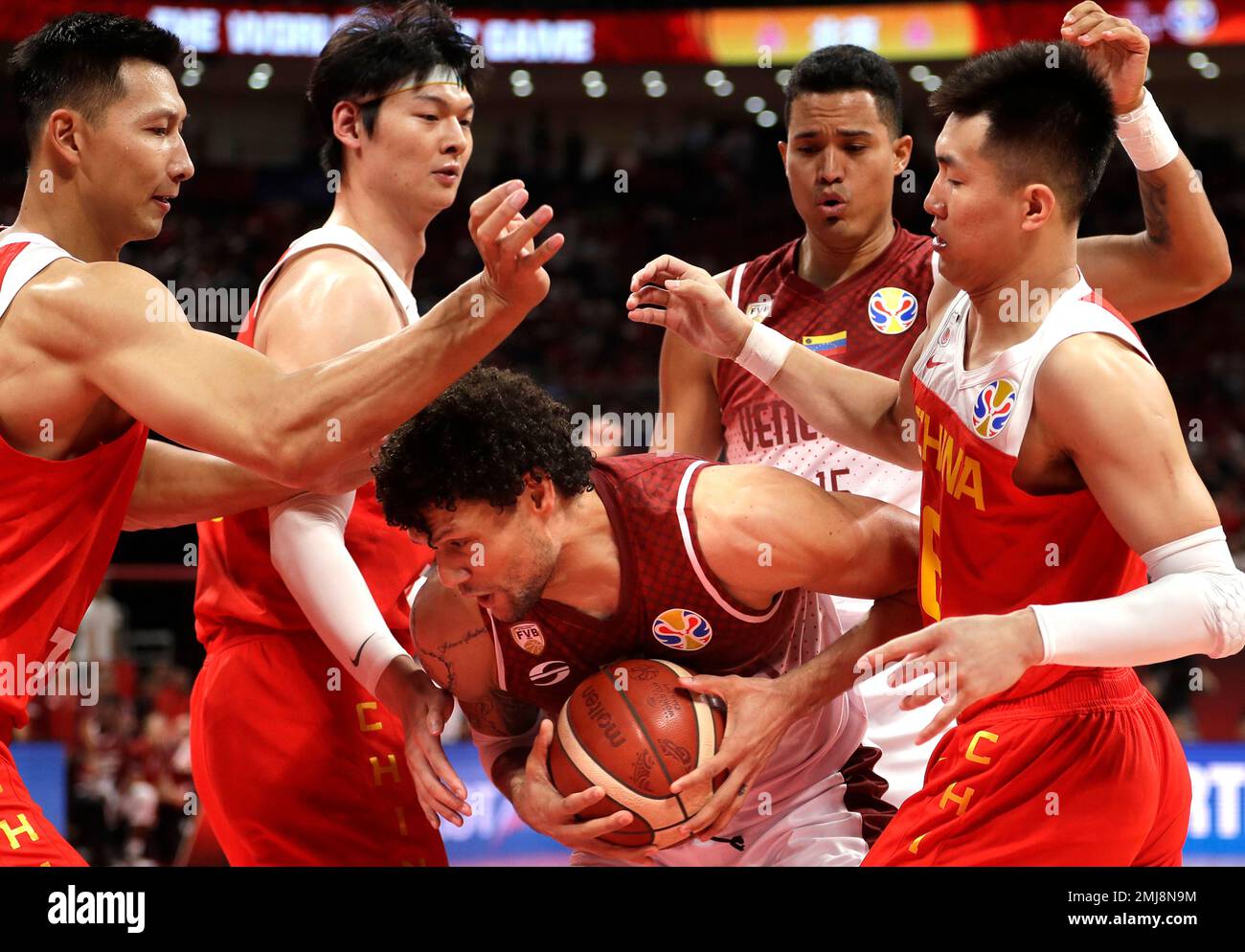 Michael Carrera of Venezuela battles for control of a loose ball with, from  left, Yi Jianlian, Wang Zhelin, and Guo Ailun of China during their group  phase basketball game in the FIBA