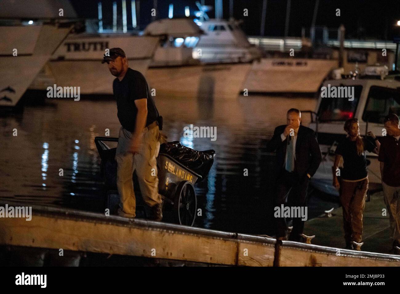 Authorities cart away evidence taken from the scuba boat Conception in