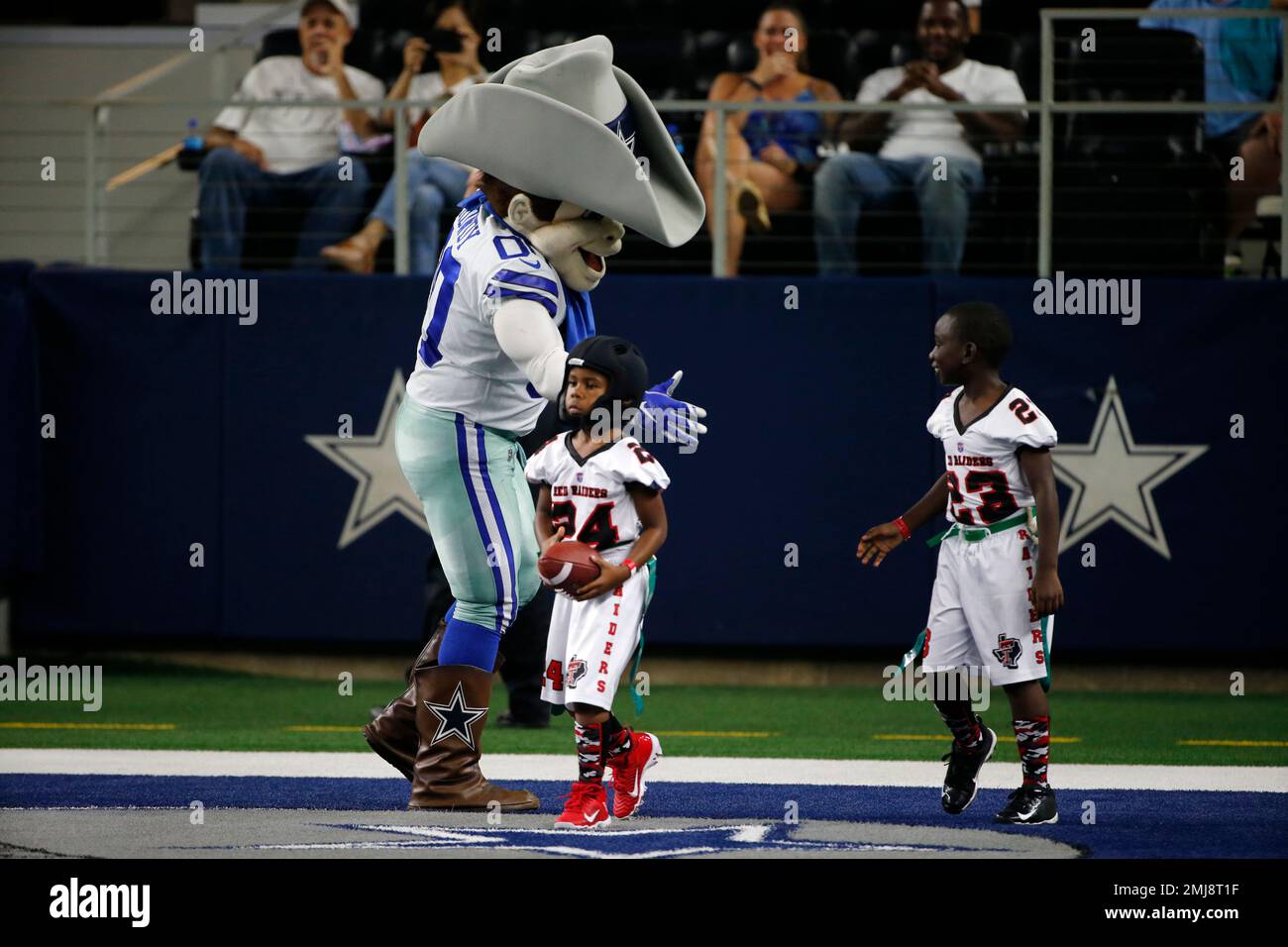 Children involved with Play 60 run onto the field to participate in a game  of flag football during half time of a preseason NFL football game between  the Tampa Bay Buccaneers and