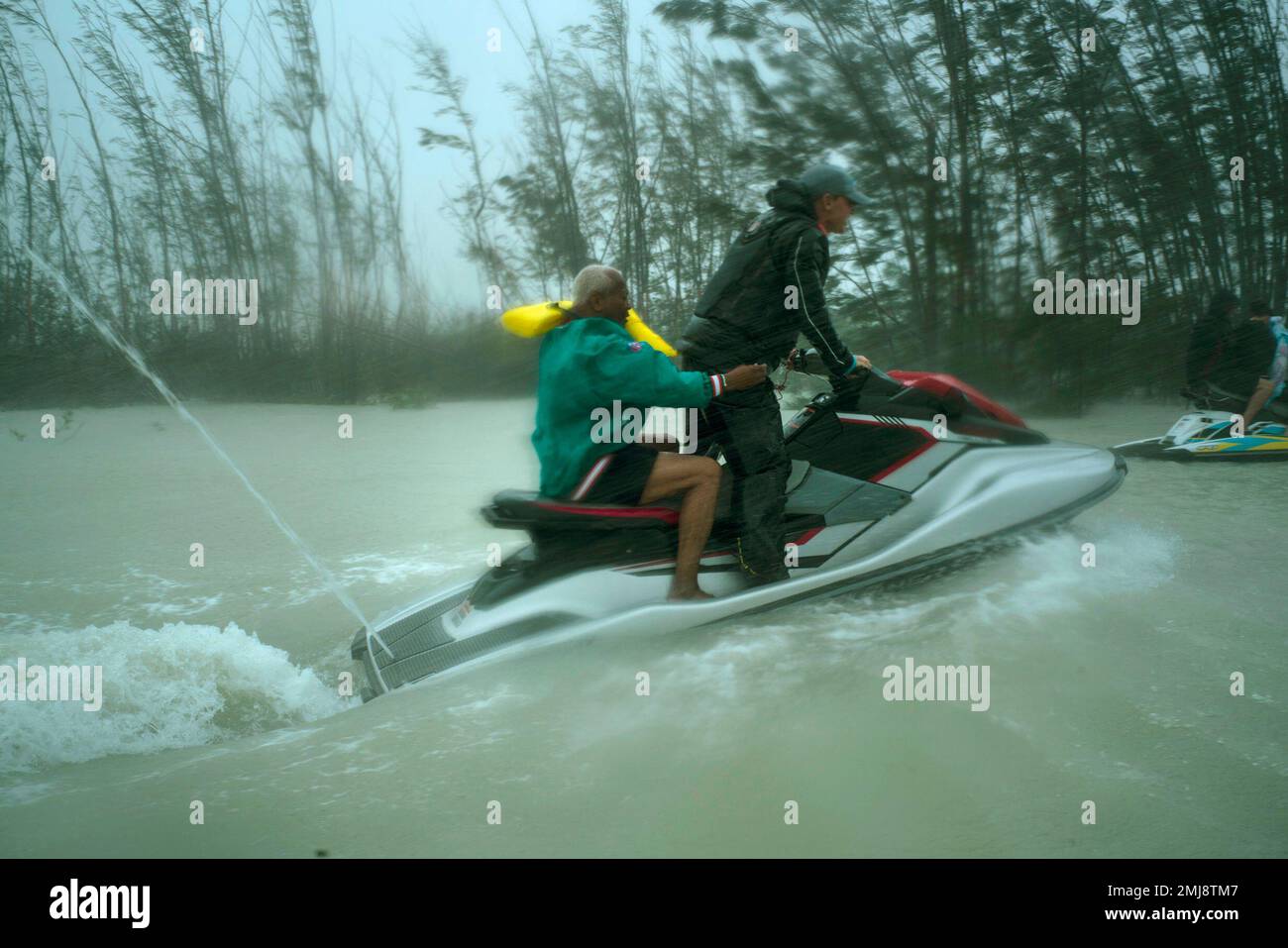A man who was trapped by flood waters during Hurricane Dorian is transported out of the area by