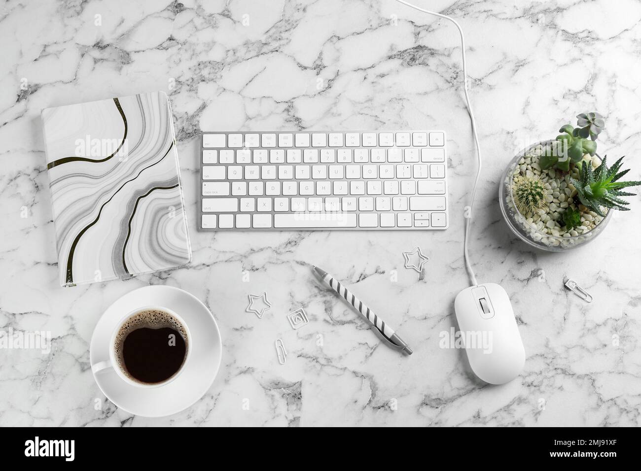 Flat lay composition with mouse and keyboard on white marble table Stock Photo
