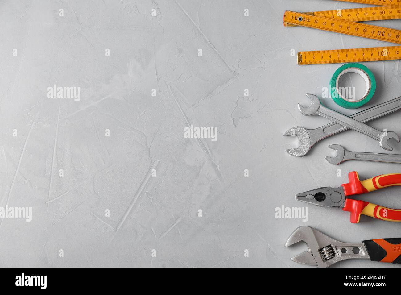 Flat lay composition with construction tools on light grey background ...