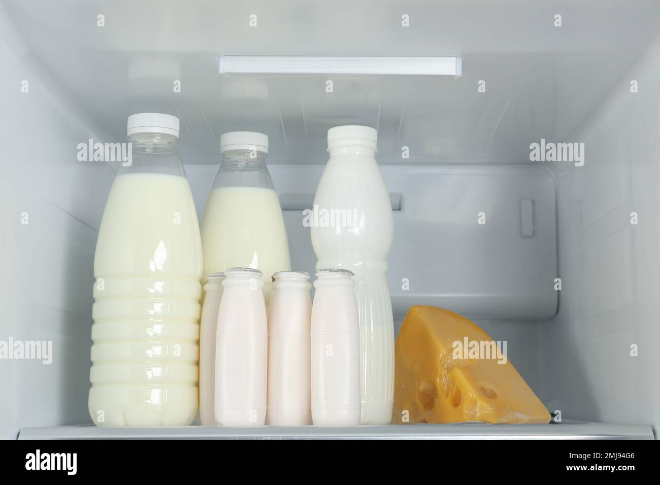 Bottles of dairy products on shelf in refrigerator Stock Photo Alamy