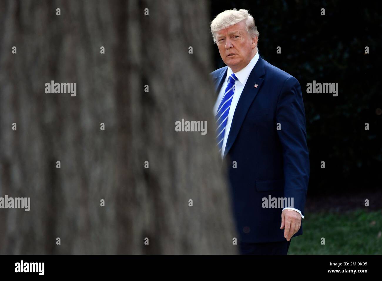 President Donald Trump walks from the Oval Office as he heads over to ...