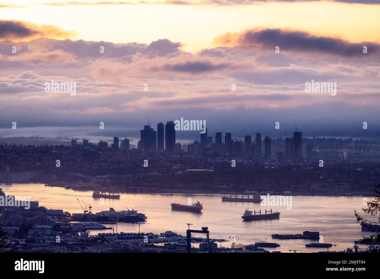 Developed city with industrial and residential buildings. Clouds in Background. Stock Photo