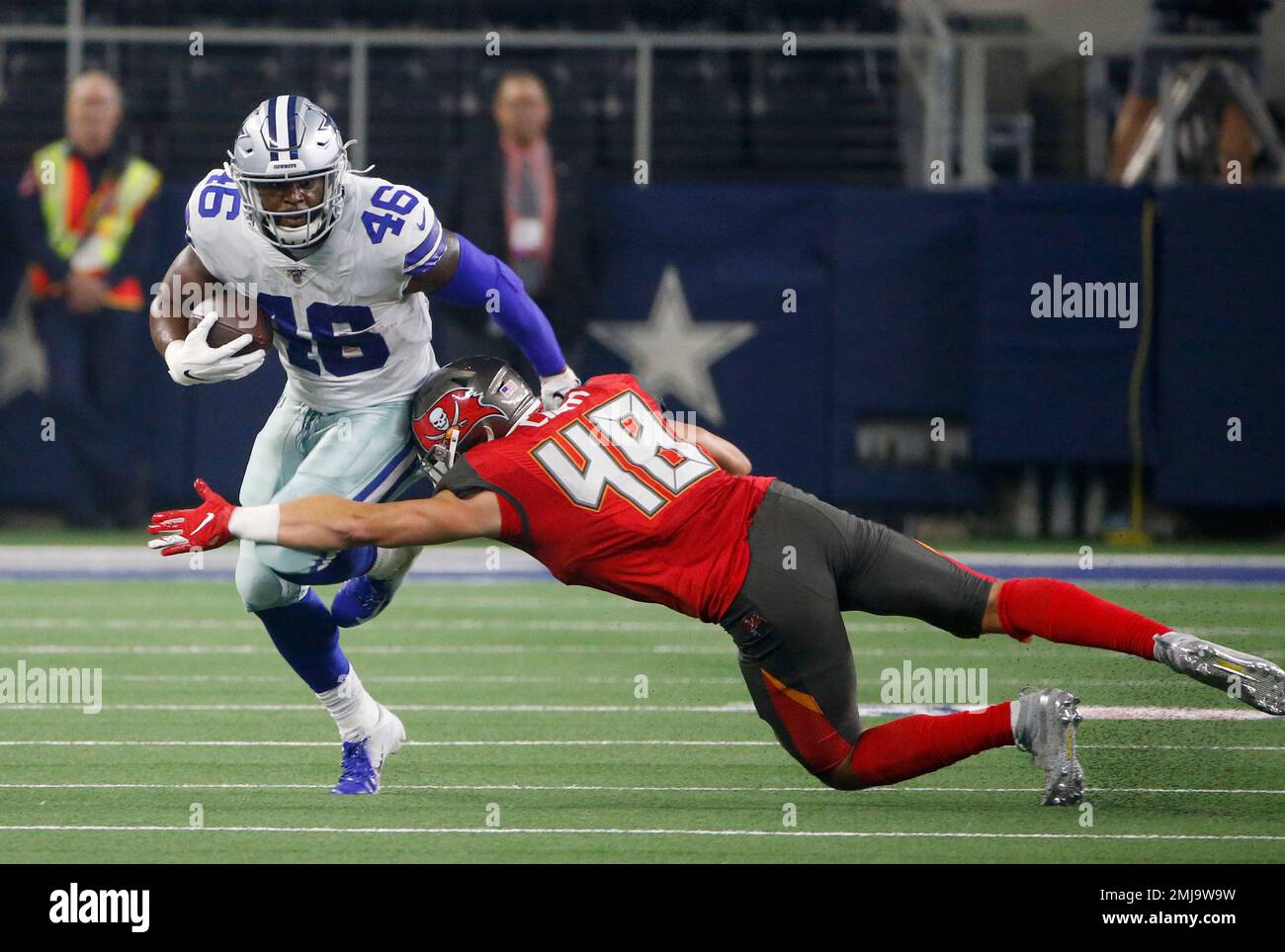 Dallas Cowboys running back Jordan Chunn (46) runs for extra yardage after  catching a pass as Tampa Bay Buccaneers linebacker Jack Cichy (48) makes  the stop in the first half of a