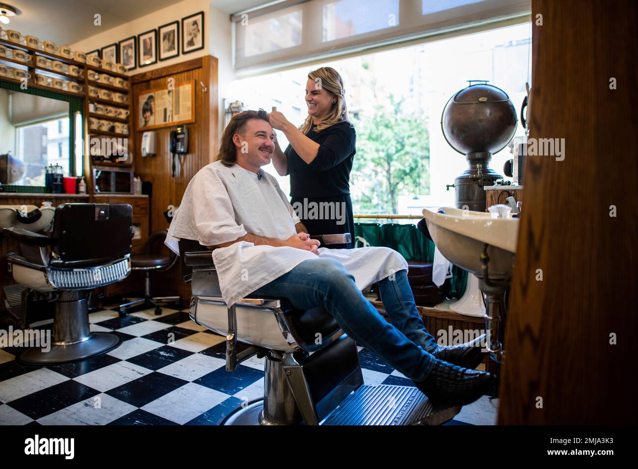 Country singer Wallen receives a mullet at Paul Mole Barber Shop