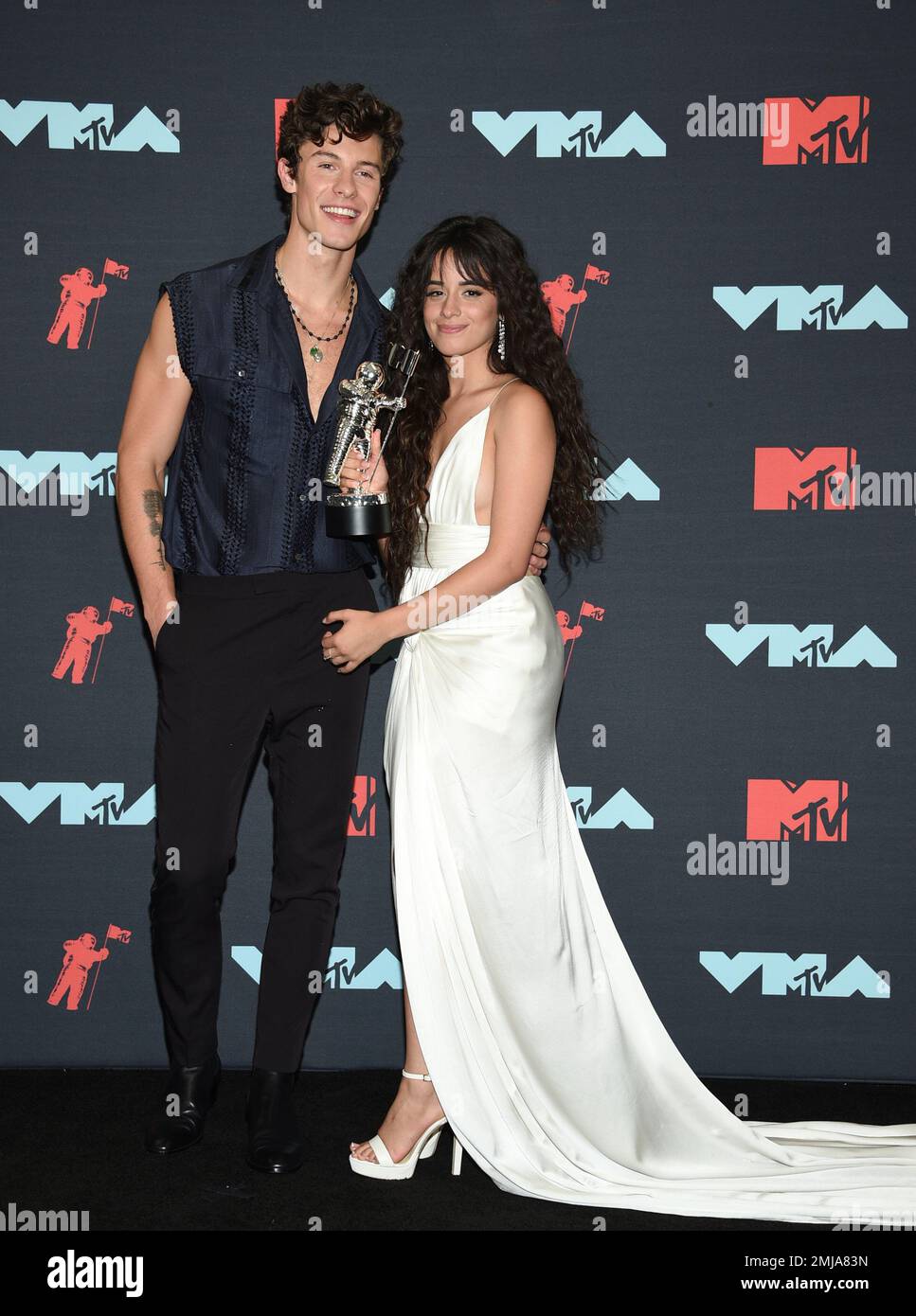 Shawn Mendes, left, and Camila Cabello pose in the press room with the