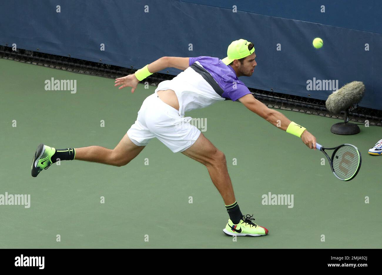 Karen Khachanov, of Russia, returns a shot to Vasek Pospisil, of Canada,  during the first round of the US Open tennis tournament Tuesday, Aug. 27,  2019, in New York. (AP Photo/Kevin Hagen