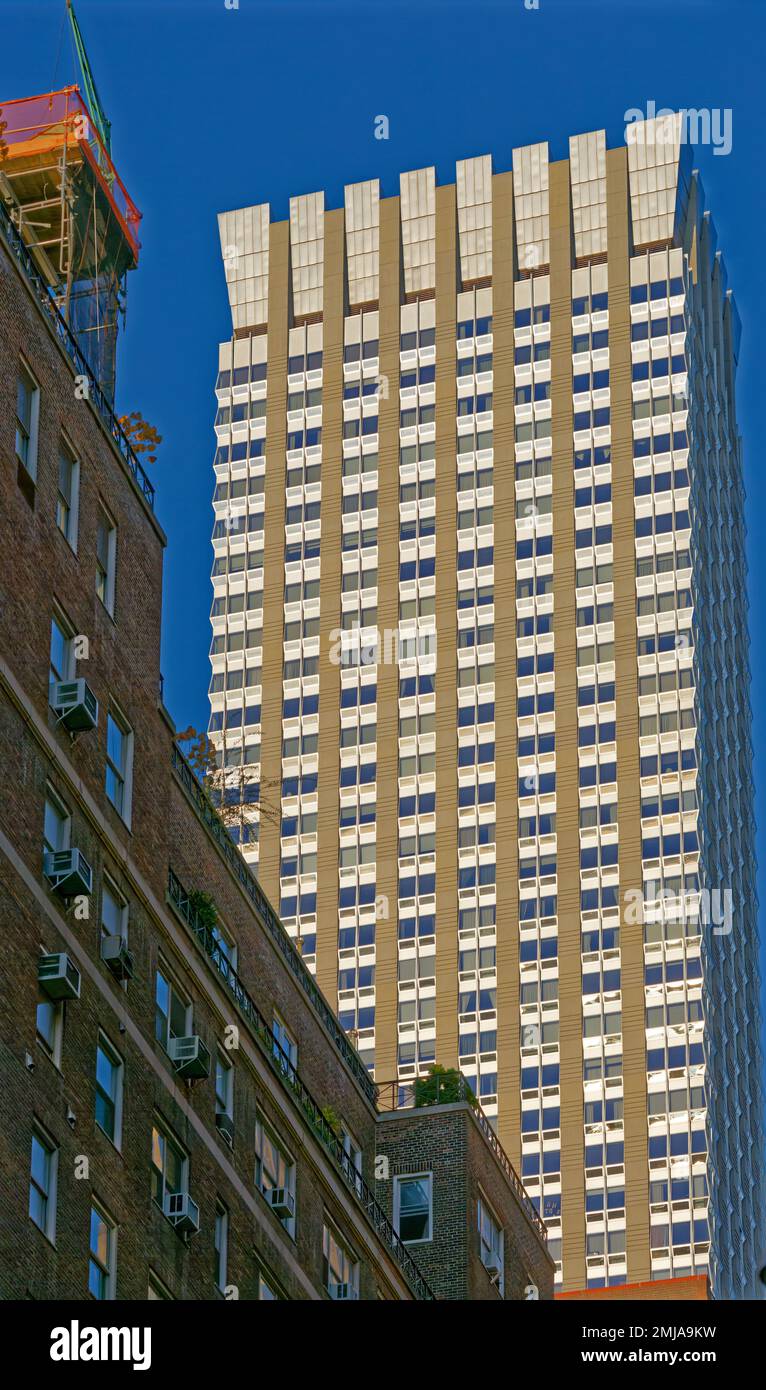 The Langham New York sports a flared stainless steel crown to hide mechanical details; the façade’s strong vertical lines emphasize height. Stock Photo