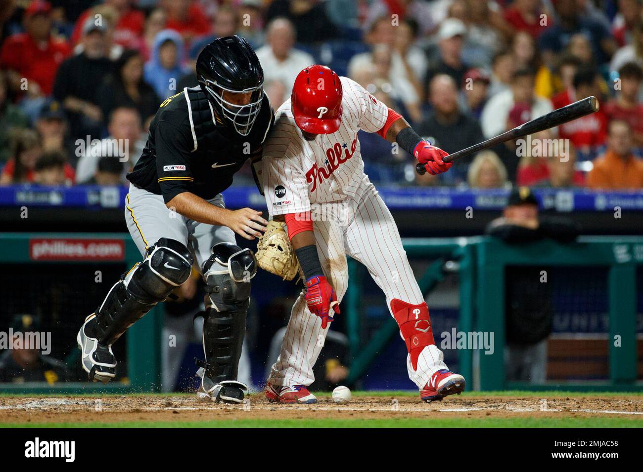 Pittsburgh Pirates catcher Jacob Stallings, left, reaches for a dropped