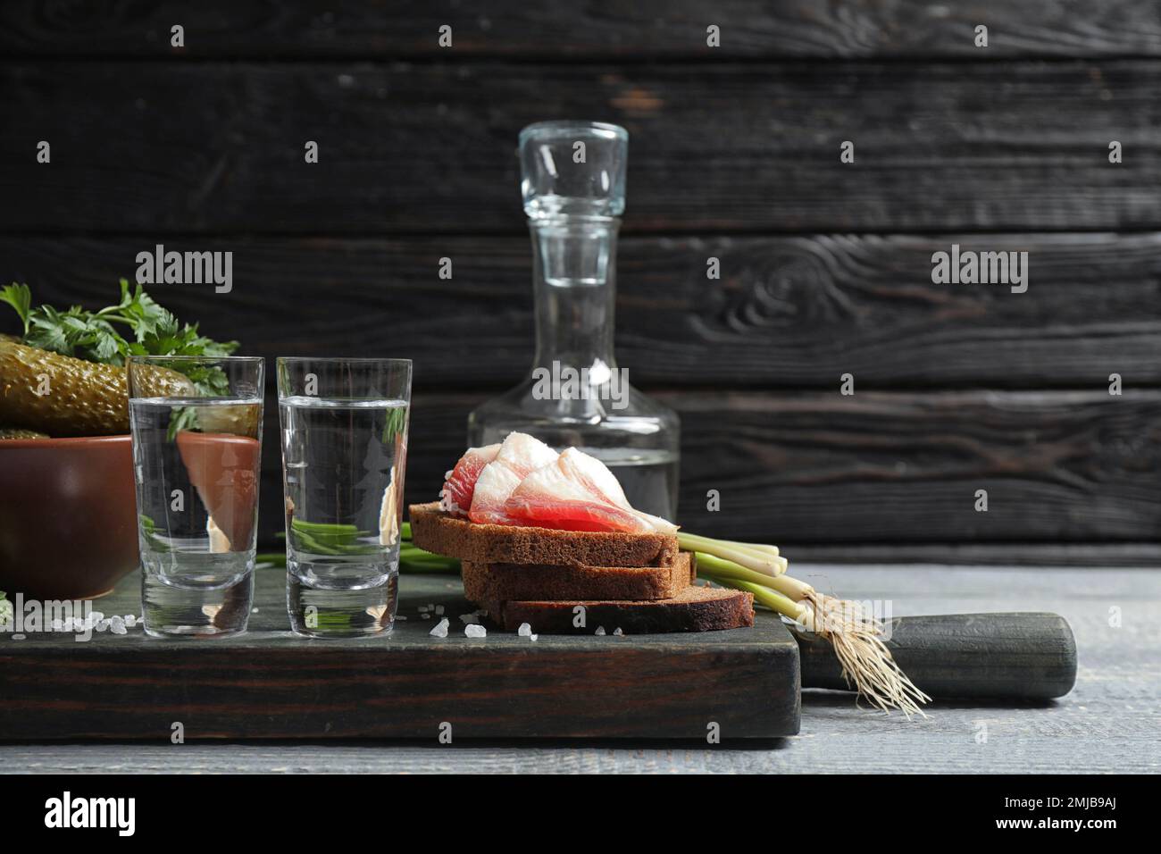 Cold Russian vodka with snacks on wooden table Stock Photo - Alamy