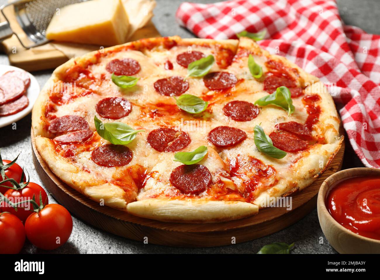 Hot delicious pepperoni pizza on grey table Stock Photo