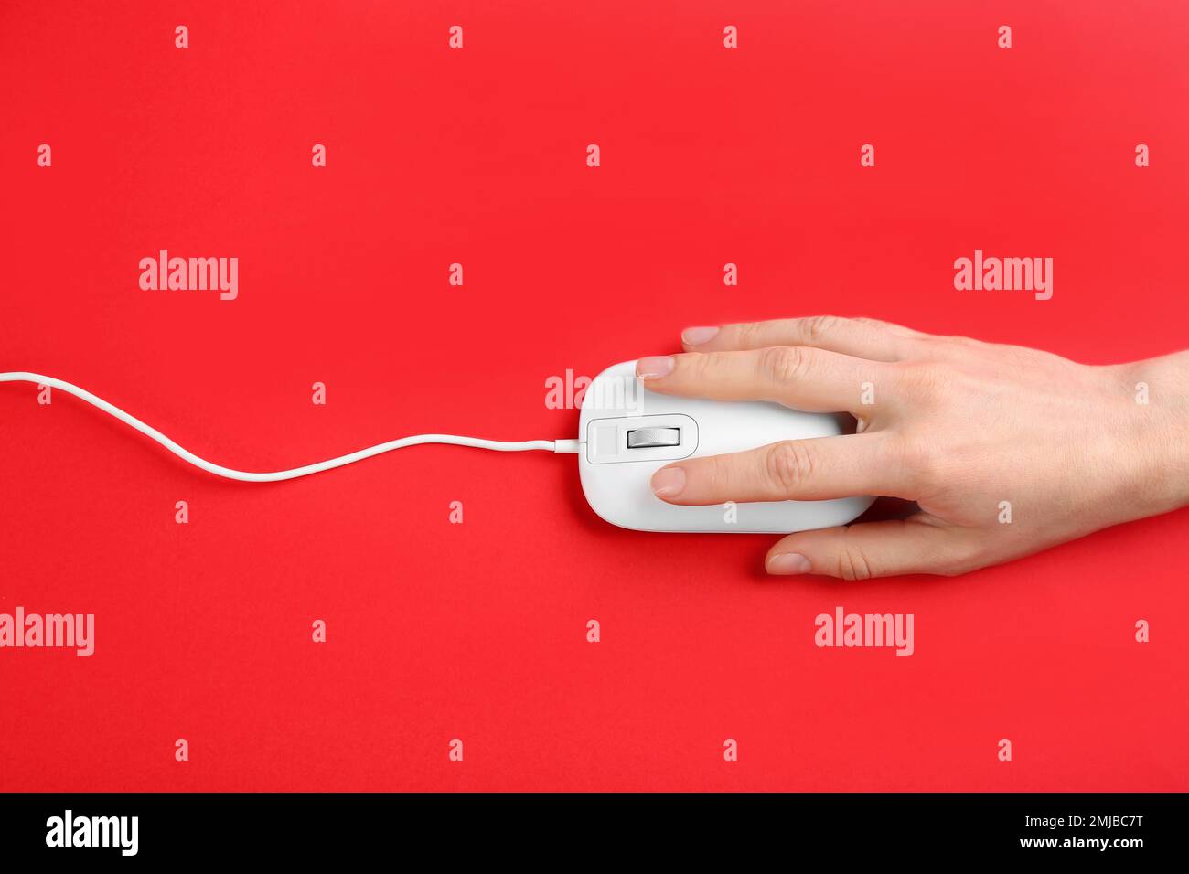 Using Mouse Top View Woman using modern wired optical mouse on red background, top view ...