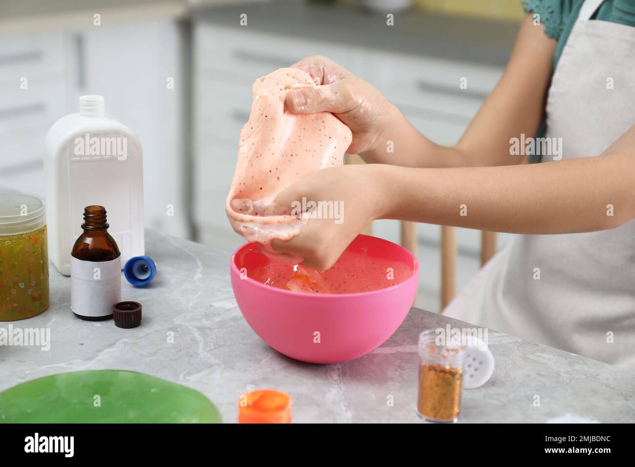 Little girl kneading DIY slime toy at table indoors, closeup Stock Photo -  Alamy