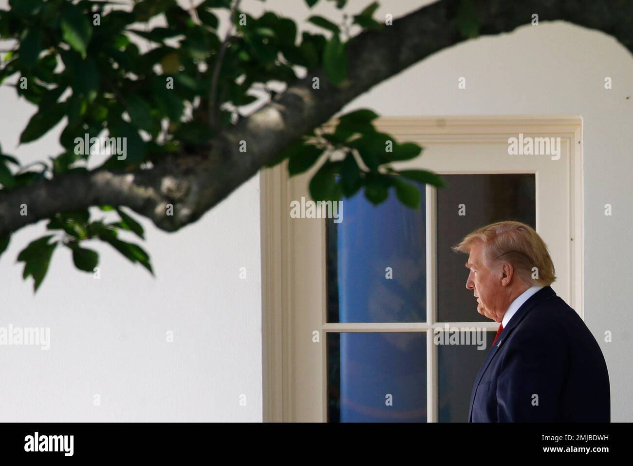 President Donald Trump walks out of the Oval Office to speak with ...
